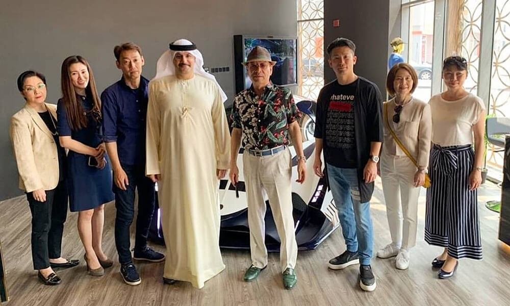 Devel Motors Majid AlAttar with Tetsumi Shinchi and Family in front of the Devel Sixteen